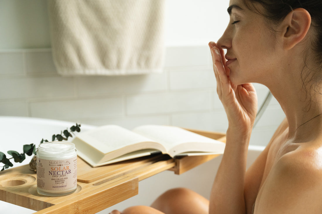 Woman enjoying the smell of Solar Nectar Nude Ritual Whipped Tallow, in a calm serene spa setting.